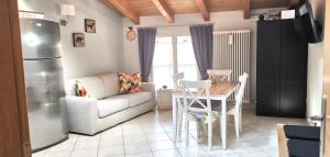 a kitchen and living room with a couch and a table at Appartamento En Mez al Paes in Dimaro +17 photos