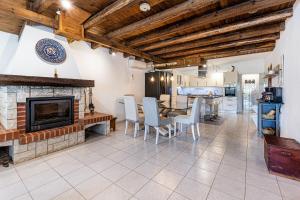 a living room with a fireplace and a table and chairs at Silves Retreat by Algarve Golden Properties in Silves