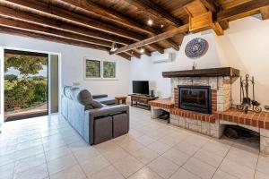 a living room with a couch and a fireplace at Silves Retreat by Algarve Golden Properties in Silves