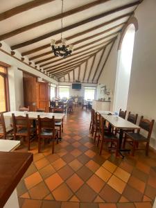 a dining room with tables and chairs in a building at Hotel Casa Campestre Villa Anita in Villa de Leyva