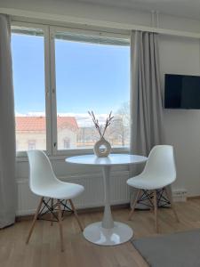 a table and two chairs in a room with a window at Studio Apartment Station in Oulu