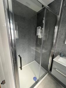 a shower with a glass door in a bathroom at The Annexe in Felton
