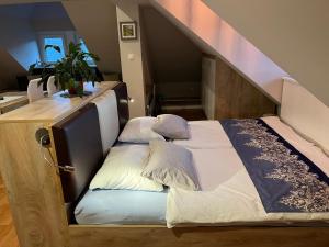 a bed in a room with a stair case at Vila Lesce apartments in Lesce
