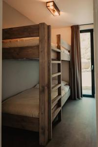a bedroom with two bunk beds and a window at Luxe schuurwoning 't Nieuwt in Chaam, Nederland in Chaam