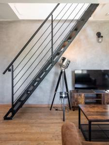 eine Treppe in einem Wohnzimmer mit einer Kamera in der Unterkunft Superbe Loft industriel - Casa Vostra - Gaillard Tram-Frontière in Gaillard