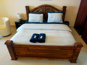 a bed with two pairs of shoes sitting on it at Sea View Studio 3 Royal Breeze Breezeسي ويو ستوديو رويال بريز in Ras al Khaimah