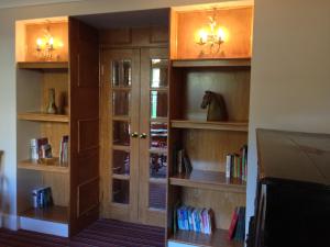 a library with wooden shelves and a horse in it at Falstone Barns in Falstone