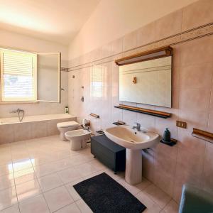 a bathroom with a sink and a toilet at Biancaspuma in Marsala