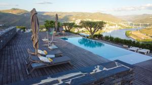 a pool with chairs and umbrellas on a roof at Quinta Pecêga - AL in Peso da Régua +19 photos