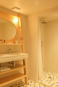 a bathroom with a sink and a shower at Hotel des Dunes in Cap-Ferret