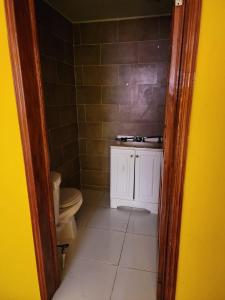 a bathroom with a toilet and a sink at Super Two Bedroom Penthouse in Peguy-Ville 