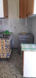 a small kitchen with a sink and a stove at Casotti in Cutigliano