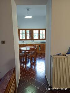 a kitchen and dining room with a table and chairs at Archontiko Taxiarches Kymi Evia in Kymi