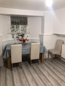 a dining room with a table and chairs at En Suite Double Room 2 in Plumstead