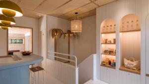 a bathroom with a staircase and a sink and a mirror at Hotel des Dunes in Cap-Ferret
