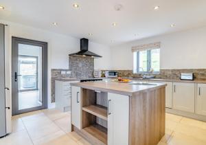 a kitchen with a large island with a counter top at USK Barn in Llanbadoc