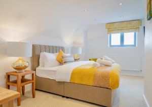 a bedroom with a bed and a table and a window at USK Barn in Llanbadoc