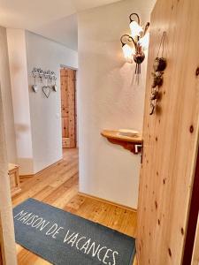 a room with a door with a sign that says vision of wellness at Cà Val Forno - Vacanze con stile in Maloja