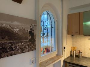 a kitchen with a window with a picture on the wall at Apartment Skischanze in Garmisch-Partenkirchen