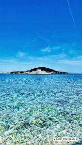 an island in the middle of a large body of water at Apartment Marta in Preko