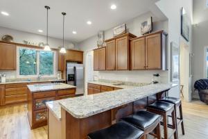 a kitchen with wooden cabinets and a large island with bar stools at The Pointe at North View in Banner Elk