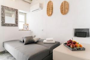 a bed in a room with a bowl of fruit at Afluencia Complex Studio No7 in Naousa