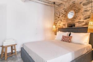 a bedroom with a bed with a mirror on the wall at Afluencia Complex Studio No7 in Naousa