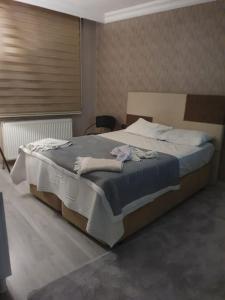 1 dormitorio con 1 cama grande en una habitación en Mükemmel Konumda Lüx Family Concept Daire, en Sivas