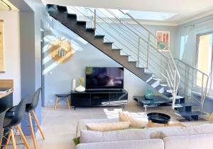 a living room with a couch and a staircase at Le Bellavista in Cassis