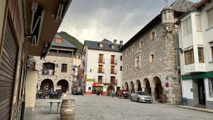 a city street with buildings and a car on the road at Apartamento Rosa Bielsa in Bielsa