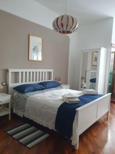 a bedroom with a large bed with blue pillows at Ospitalità Il NOCE in Brusciano