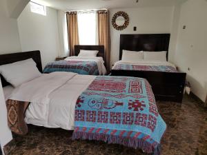 Hostal Killaly Inn Cusco客房内的一张或多张床位