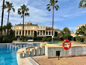 a swimming pool with a life ring in front of a building at Las Delas in Denia