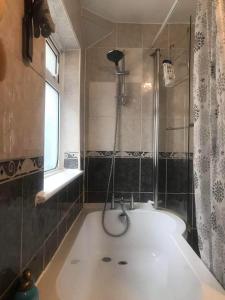 a bathroom with a bath tub with a shower at Double Room Central Location in London
