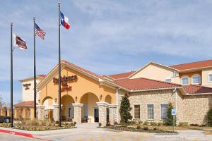 a hotel with two flags in front of a building at Residence Inn by Marriott Abilene in Abilene