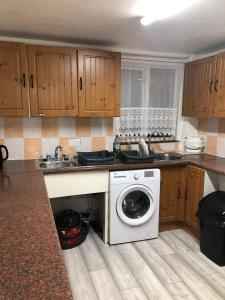 a kitchen with a washing machine and a sink at Double Room Central Location in London