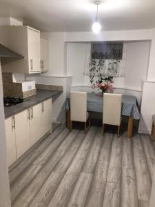 a kitchen with a table and chairs in a room at Double Room Central Location in London