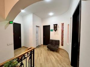 a living room with a leather chair in a hallway at Tamarisi Old Tbilisi in Tbilisi City +40 photos