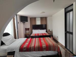 Hostal Killaly Inn Cusco客房内的一张或多张床位