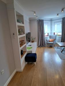 a living room with a couch and a table at Pokoje De Luxe Figaro in Płock