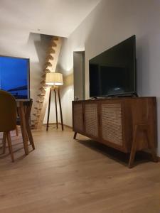 a living room with a large flat screen tv at Appartement sur Terrasse in Capbreton