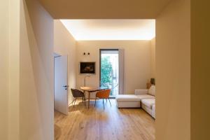 a living room with a white couch and a table at FilHome 44 in Catania