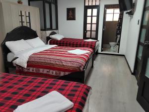 Hostal Killaly Inn Cusco客房内的一张或多张床位
