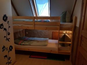 a couple of bunk beds in a room at Fewo am Saalerbodden in Bartelshagen