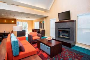 a living room with a couch and a fireplace at Residence Inn Topeka in Topeka