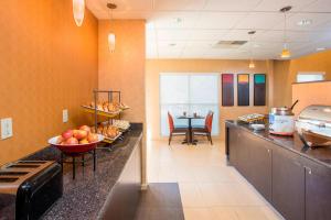 a kitchen with a counter with a bowl of fruit on it at Residence Inn Topeka in Topeka