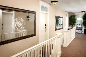 a large mirror on a wall in a hallway with a stairway at Historic Branson Hotel - Horseshoe Room with King Bed - Downtown - FREE TICKETS INCLUDED in Branson
