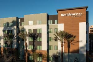a rendering of a building with palm trees in front at Residence Inn by Marriott Anaheim Brea in Brea