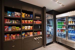 a kitchen with a refrigerator and lots of food at Courtyard Dallas Grand Prairie in Grand Prairie