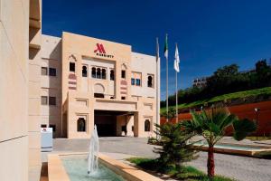 a building with a fountain in front of it at Constantine Marriott Hotel in Constantine